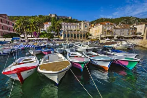 Boats docked at marina with the Venetian Loggia and the Hvar Fortress overlooking the harbour at the Old Town of Hvar Boats docked at marina with the Venetian Loggia and the Hvar Fortress overlooking the harbour at the Old Town of Hvar