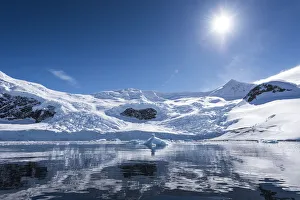 Bright Sun And Snow On The Mountains Reflected In The Water Of Neko Harbour; Antarctica Bright Sun And Snow On The Mountains Reflected In The Water Of Neko Harbour; Antarctica