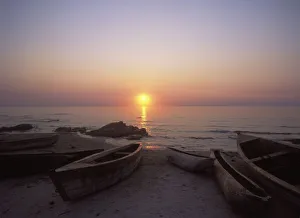 Canoes And Fishing Boats On Beach By Lake Malawi, Sunset Canoes And Fishing Boats On Beach By Lake Malawi, Sunset