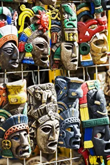 Close Up Of Colourfully Painted Mayan Masks Hanging On Display; Akumal, Quintana Roo Close Up Of Colourfully Painted Mayan Masks Hanging On Display; Akumal, Quintana Roo