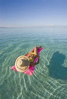 French Polynesia, Tahiti, Moorea, Woman Floating In Water French Polynesia, Tahiti, Moorea, Woman Floating In Water