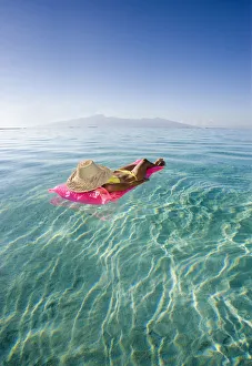 French Polynesia, Tahiti, Moorea, Woman Floating In Water French Polynesia, Tahiti, Moorea, Woman Floating In Water