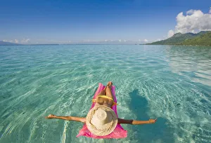 French Polynesia, Tahiti, Moorea, Woman Floating In Water French Polynesia, Tahiti, Moorea, Woman Floating In Water