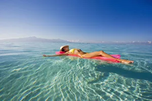 French Polynesia, Tahiti, Moorea, Woman Floating In Water French Polynesia, Tahiti, Moorea, Woman Floating In Water