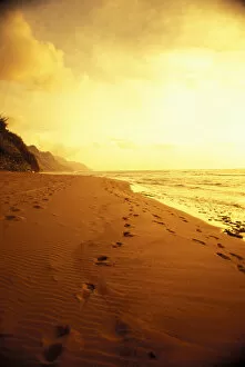 Images Dated 3rd September 1997: Hawaii, Kauai, Na Pali Coast, Beach At Sunset With Footprints In Sand, Golden Sky And Water
