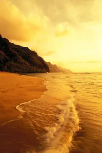 Hawaii, Kauai, Na Pali Coast, Beach At Sunset, With Foamy Surf And Cliff In Background Hawaii, Kauai, Na Pali Coast, Beach At Sunset, With Foamy Surf And Cliff In Background