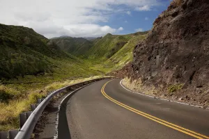 Hawaii, Maui, A winding road through Maui's west side with lush mountains Hawaii, Maui, A winding road through Maui's west side with lush mountains
