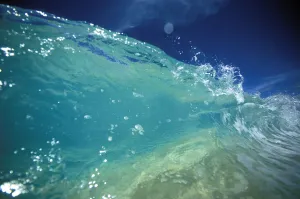 Hawaii, Turquoise Breaking Wave, Sand Visible Through Clear Water, Blue Sky. Close-Up Hawaii, Turquoise Breaking Wave, Sand Visible Through Clear Water, Blue Sky. Close-Up