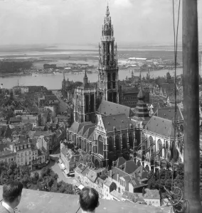 Historic image in black and white of people viewing landmarks from a rooftop Historic image in black and white of people viewing landmarks from a rooftop