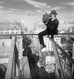 Historic image in black and white of a photographer sitting on a slender girder above fifth avenue in New York City Historic image in black and white of a photographer sitting on a slender girder above fifth avenue in New York City