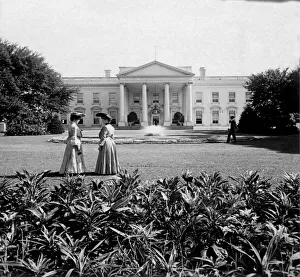 Historic image in black and white of two women and a man standing on the White House lawn in Washington DC Historic image in black and white of two women and a man standing on the White House lawn in Washington DC