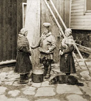 Historic image in sepia tone of women wearing shawls standing together and a dog lying on the ground with them Historic image in sepia tone of women wearing shawls standing together and a dog lying on the ground with them