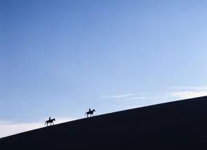 Horse Riders At Dusk On A Sand Dune In The Valle De La Muerte In Cordillera De La Horse Riders At Dusk On A Sand Dune In The Valle De La Muerte In Cordillera De La
