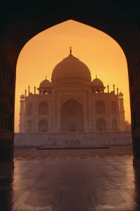 India, Agra, View Of Taj Mahal Through Archway Of Adjacent Building, Orange Sunset Sky India, Agra, View Of Taj Mahal Through Archway Of Adjacent Building, Orange Sunset Sky