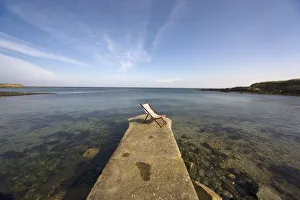 Lonely Deckchair At The Edge Of Pier; Northumberland, England, Uk Lonely Deckchair At The Edge Of Pier; Northumberland, England, Uk