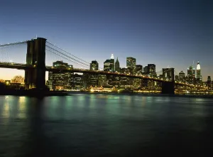 Looking Across The East River And The Brooklyn Bridge To The Financial District At Dusk Looking Across The East River And The Brooklyn Bridge To The Financial District At Dusk
