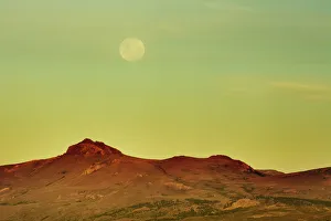 The Moon Is Rising Over A Yellow Desert Landscape; Bariloche, Argentina The Moon Is Rising Over A Yellow Desert Landscape; Bariloche, Argentina