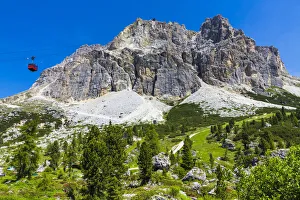 Mountain side view of the Falzarego Pass with an aerial cable car in the Dolomites in the Province of Belluno, Italy Mountain side view of the Falzarego Pass with an aerial cable car in the Dolomites in the Province of Belluno, Italy