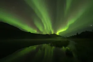 Northern Lights glowing a vibrant green in the Yukon night sky; Watson Lake, Yukon, Canada Northern Lights glowing a vibrant green in the Yukon night sky; Watson Lake, Yukon, Canada