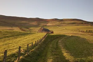 Northumberland, England; A Farm Structure And A Fence Around A Field Northumberland, England; A Farm Structure And A Fence Around A Field