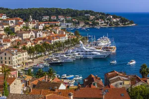 Overview of clay tile rooftops and luxury yachts docked in marina at the Old Town of Hvar on Hvar Island, Croatia Overview of clay tile rooftops and luxury yachts docked in marina at the Old Town of Hvar on Hvar Island, Croatia