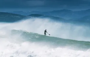 Paddleboarding In The Waves Along The Coast Of Cape Trafalgar; Cadiz, Andalusia, Spain Paddleboarding In The Waves Along The Coast Of Cape Trafalgar; Cadiz, Andalusia, Spain