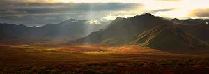 Panoramic Image Of The Cloudy Range With Shafts Of Sunlight Hitting The Fall Colours Of The Dempster Highway, Yukon Panoramic Image Of The Cloudy Range With Shafts Of Sunlight Hitting The Fall Colours Of The Dempster Highway, Yukon