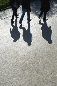 Pedestrians And Their Shadows On A Walkway; Paris, France Pedestrians And Their Shadows On A Walkway; Paris, France