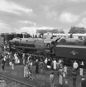 People viewing steam train Evening Star by engine shed; England People viewing steam train Evening Star by engine shed; England