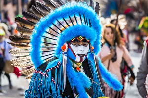 Portrait of male, indigenous tribal dancer wearing blue feathered headdress Portrait of male, indigenous tribal dancer wearing blue feathered headdress