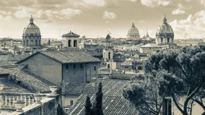Rome, Italy. Rooftops and domes. In the far distance is St. Peter's. The historic centre of Rome is a UNESCO World Rome, Italy. Rooftops and domes. In the far distance is St. Peter's. The historic centre of Rome is a UNESCO World