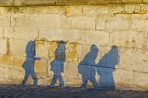 Shadows Of Pedestrians Cast On A Wall; Paris, France Shadows Of Pedestrians Cast On A Wall; Paris, France