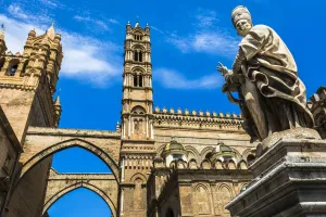 Statue of Archbishop and arcades connecting main building to the palace at the Palermo Cathedral in historic Palermo in Statue of Archbishop and arcades connecting main building to the palace at the Palermo Cathedral in historic Palermo in