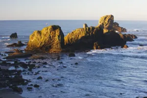 Sun Shining On The Rocks At Sunrise At Ecola State Park; Oregon, United States Of America Sun Shining On The Rocks At Sunrise At Ecola State Park; Oregon, United States Of America