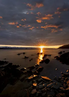 Sunset reflecting golden light on the water and rock formations of Lynn Canal, Alaska, USA Sunset reflecting golden light on the water and rock formations of Lynn Canal, Alaska, USA