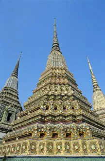 Images Dated 30th April 2000: Thailand, Bangkok, Colorful Pointed Steeples Against Clear Blue Sky; Wat Po