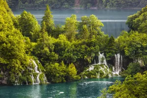 Waterfalls with turquoise water surrounded by trees at the Plitvice Lakes National Park in Lika-Senj county in Croatia Waterfalls with turquoise water surrounded by trees at the Plitvice Lakes National Park in Lika-Senj county in Croatia