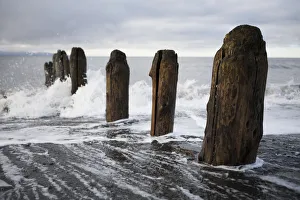 Waves Splashing Against Wooden Tide Posts In Kachemak Bay; Alaska, United States Waves Splashing Against Wooden Tide Posts In Kachemak Bay; Alaska, United States