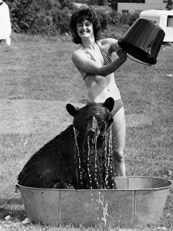 18 yr old Clair Kavan gives Daley the bear an ice cold bath to beat the heat wave 18 yr old Clair Kavan gives Daley the bear an ice cold bath to beat the heat wave