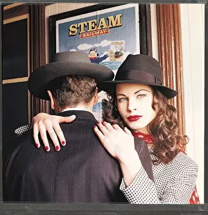 Images Dated 23rd February 1995: 1940s dress fashion - Female model wearing black hat with her arms around male model