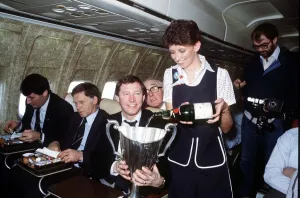 Aberdeen manager Alex Ferguson receives champagne for an air hostess inthe European Cup Aberdeen manager Alex Ferguson receives champagne for an air hostess inthe European Cup
