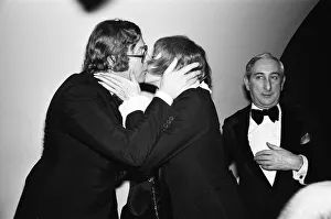 Actor Michael Caine gives a kiss to American actress Shirley MacLaine as he greets her at Actor Michael Caine gives a kiss to American actress Shirley MacLaine as he greets her at