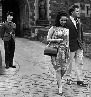 Actress Elizabeth Taylor with her husband Richard Burton walk away disappointed after not Actress Elizabeth Taylor with her husband Richard Burton walk away disappointed after not