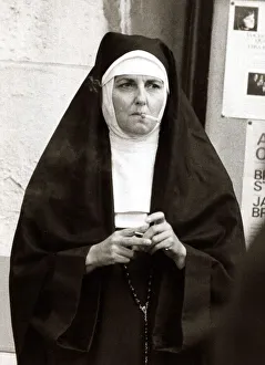 Actress playing the part of a nun takes a cigarette break during filming for A Man Called Actress playing the part of a nun takes a cigarette break during filming for A Man Called