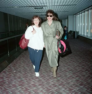 Images Dated 8th April 1990: Actresses Joan Collins and Pauline Collins at Heathrow Airport. 8th April 1990