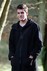 Adam Sinclair actor January 1999 in park, wearing a black coat, hands in pockets Adam Sinclair actor January 1999 in park, wearing a black coat, hands in pockets