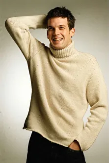 Adam Sinclair Actor January 1999 Studio picture White jumper collar Black trousers Adam Sinclair Actor January 1999 Studio picture White jumper collar Black trousers