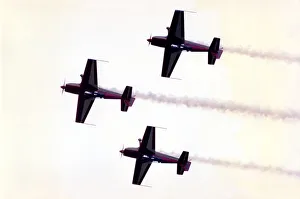 Aircraft from aerobatic display team perform at an airshow Aircraft from aerobatic display team perform at an airshow
