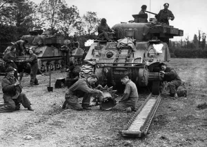 An armoured regiment overhauling one of their tanks Sherman for further battle against An armoured regiment overhauling one of their tanks Sherman for further battle against