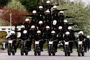 Army Regiment Royal Signals White Helmets performing a human pyramid stunt on motorbikes Army Regiment Royal Signals White Helmets performing a human pyramid stunt on motorbikes